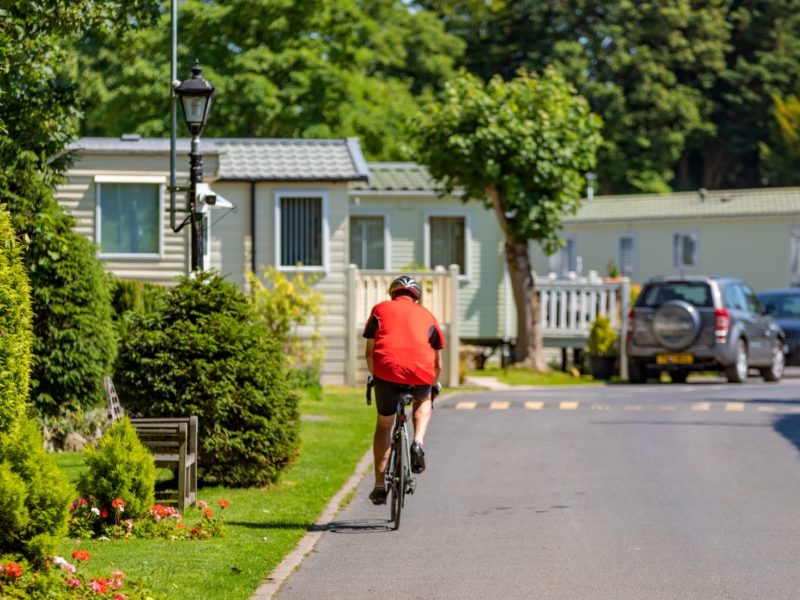 Man cycling through Mowbreck Caravan Park in Lancashire
